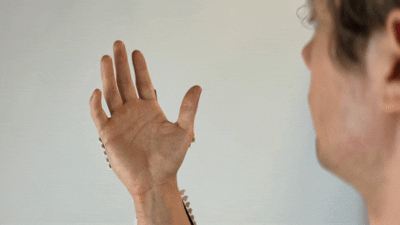 AI stimulates fingers to form an OK sign